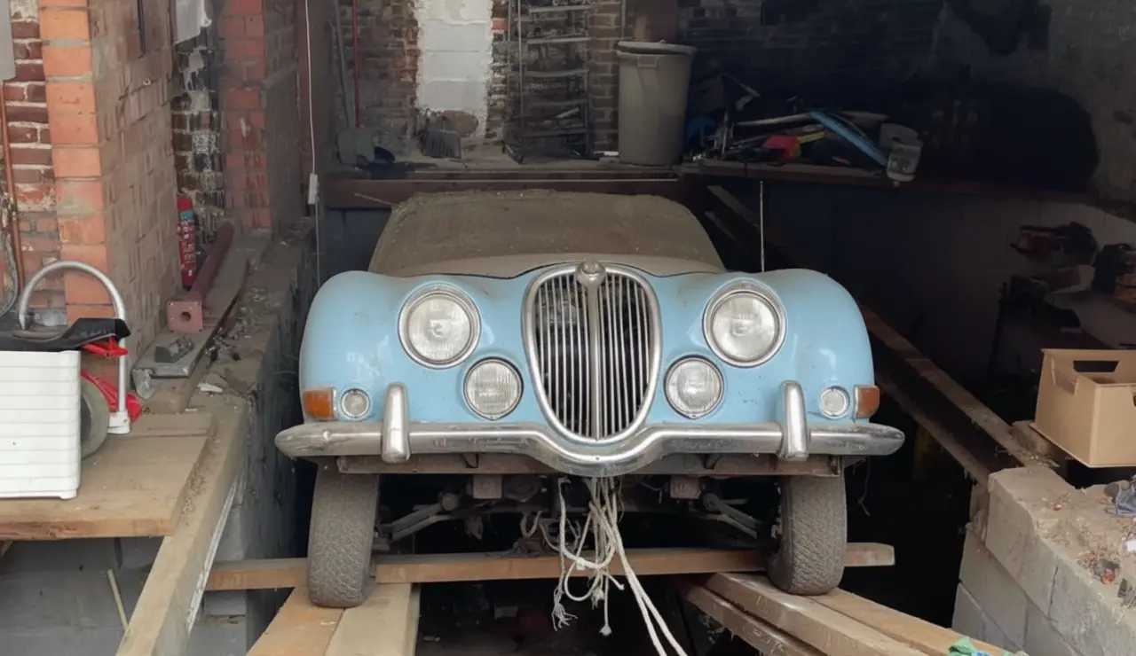 Antique dealer discovers 1964 Jaguar under garage floor while clearing house in Kessel-Lo